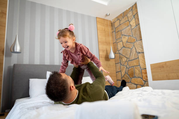 istock Father playing plane with his daughter 1445288786