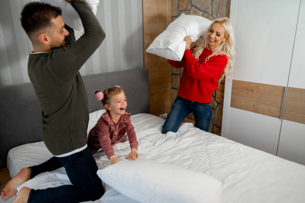 istock Happy family having a pillow fight 1445289065