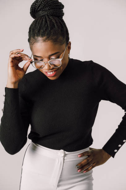 istock Cheerful woman standing and holding her eyeglass smiling 1445289711