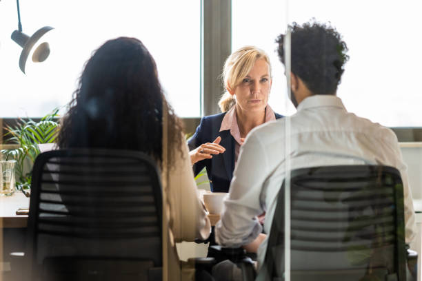 istock Female advisor talking to client couple 1445290003