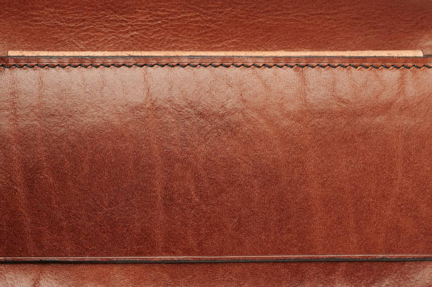 ライン付きの茶色の革の質感の表面 - leather sewing label patch ストックフォトと画像
