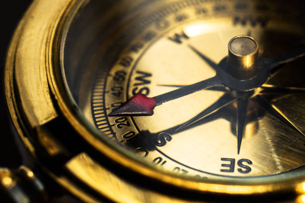 istock Golden brass compass pointing in south direction 1445303176