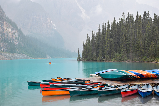 Turquoise blue lake with colorful canoes