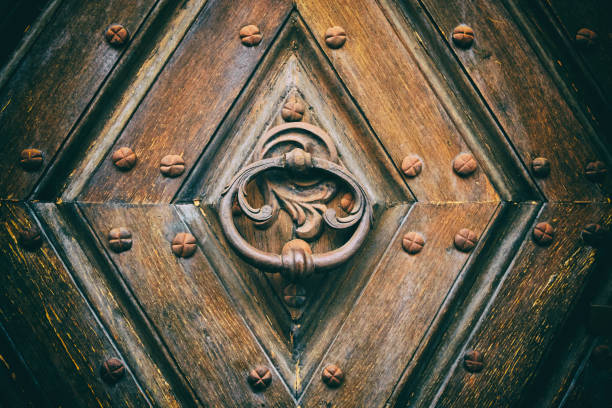 istock Antique round iron handle on an old Wooden door. 1445307373