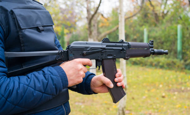 istock A man holds a Kalashnikov assault rifle in his hands side view 1445307633