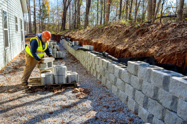 istock Concrete block wall that is being built on part new retaining wall construction project 1445316373