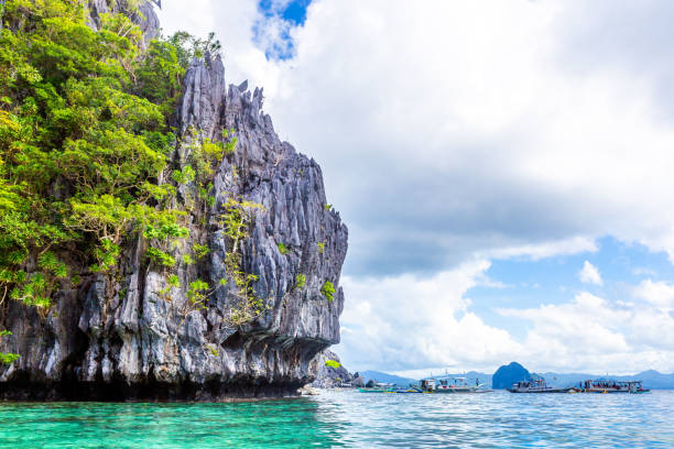 istock Boats by the Limestone Rock Formation 1445316470