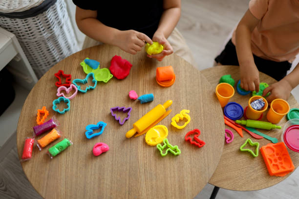 Children sculpt from plasticine, classes in a kids club, the concept of education and child development stock photo