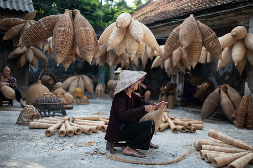 Vietnamese fishing family making baskets in Thu Sy Village, Vietnam