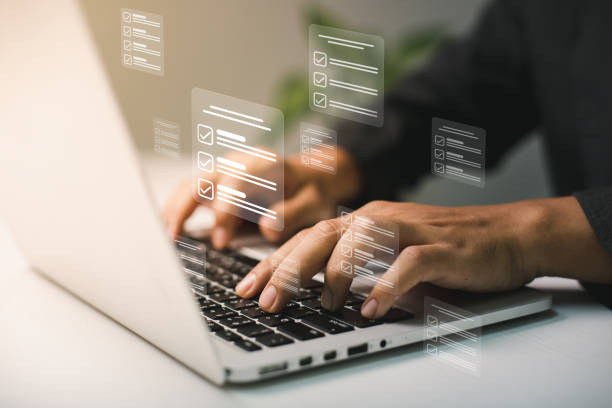 istock Businessmen use laptops to searching, managing and access information  in files online document database, for efficient archiving and company data. Document Management System (DMS) concept. 1445323283