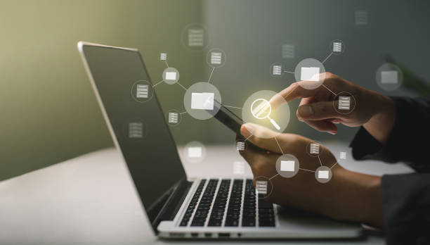istock Businessmen use laptops to searching, managing and access information  in files online document database, for efficient archiving and company data. Document Management System (DMS) concept. 1445323332