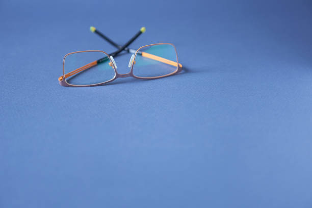 istock Glasses on blue background, close-up. 1445325937