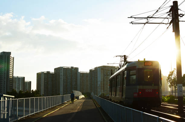 Hoi Wong Road, Tuen Mun, New Territories, Hong Kong - 22, October, 2020: MTR's Light Rail was running under the sunset in Hong Kong.