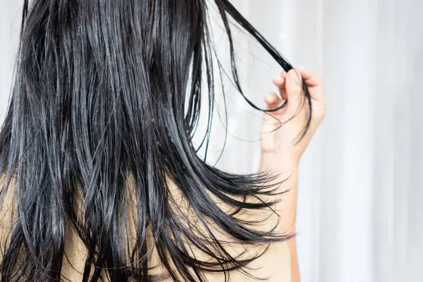 Photo of woman have problems with oily hair and thinning hair