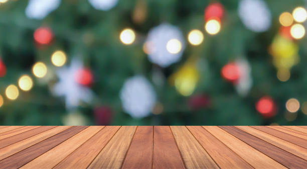istock Empty wood table top with blur Christmas tree with bokeh light background 1445326785