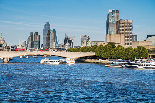 London, United Kingdom - September 17 2022: View from the bridge, Canary Wharf London City with tall buildings and Saint Paul's cathedral on the backround