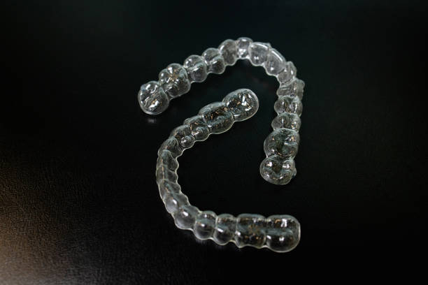 istock Night guard teeth bruxism protection isolated on the dark background 1445328218