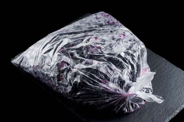 istock frozen homemade currants in a plastic bag on a stone plate on a black background, isolate 1445328400