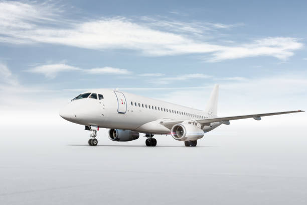 istock White passenger airplane isolated on bright background with sky 1445334183