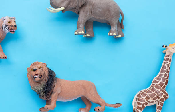 istock Plastic jungle animal toys on blue background. 1445334406