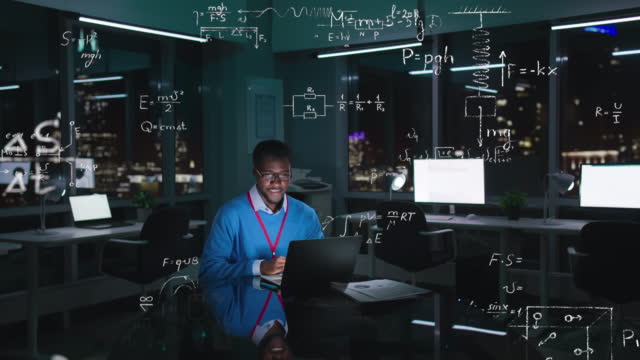 Scientist work on computer in modern office at night with holographic formulas in the air