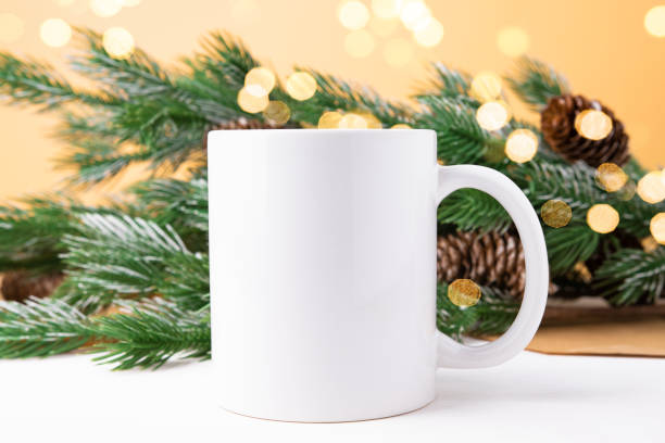 istock Mockup with white ceramic mug and Christmas tree and bokeh front view. Cup with copy space, Christmas background. 1445339448