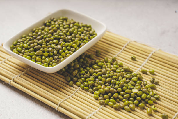 istock fresh mung beans in ceramic dishes against a white stone background, coppy space. 1445339599