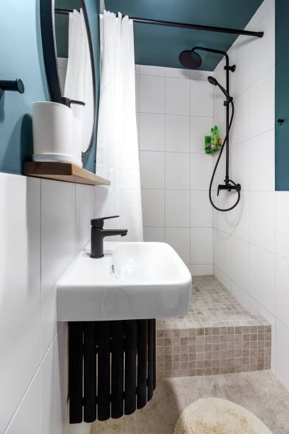 istock Modern interior design of a small bathroom. Blue style. Black plumbing 1445340586