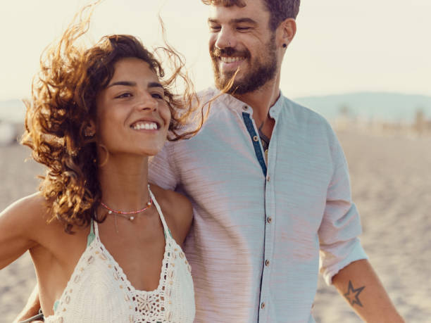 istock Happy couple walking on the beach. 1445343557