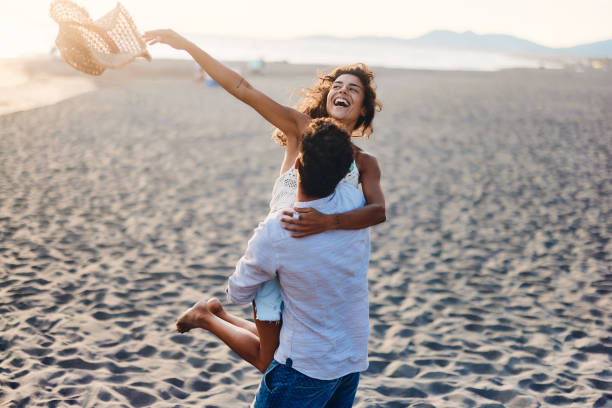 istock Carefree couple having fun on the beach. 1445344350