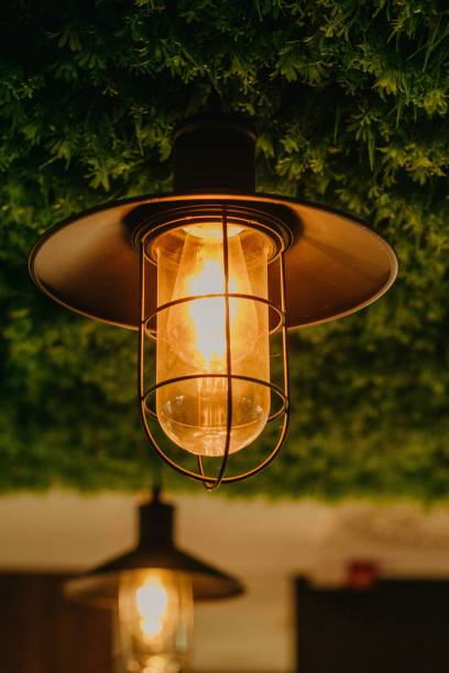 istock Vertical closeup of a lamp with a yellow glow. 1445349267