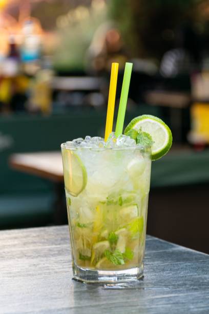 istock Vertical closeup shot of a cold Mojito Cocktail with two straws on a table 1445350277