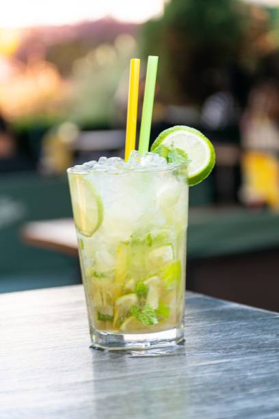 istock Vertical closeup shot of a cold Mojito Cocktail with two straws on a table 1445350286