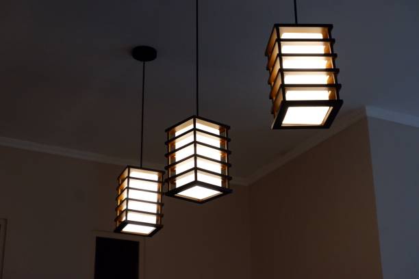istock Low angle shot of modern-style lamps hanging on a ceiling 1445350366