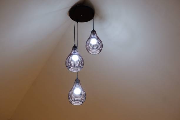 istock Low angle shot of modern-style lamps hanging on a ceiling 1445350370