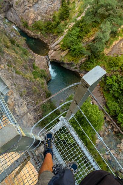 istock Vertical shot from a metallic bridge of a river between cliffs 1445351053