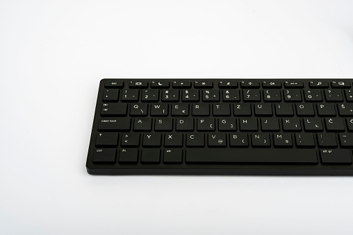 A low-angle shot of a computer keyboard isolated on a white background