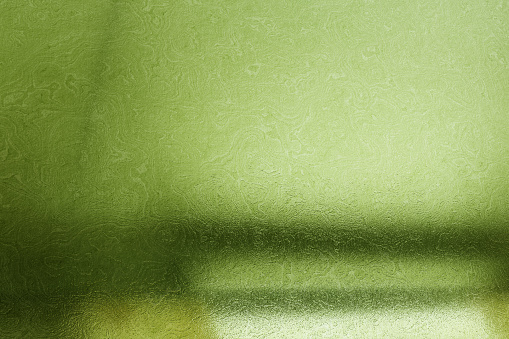 Brushed green metallic wall with scratched surface, abstract texture background