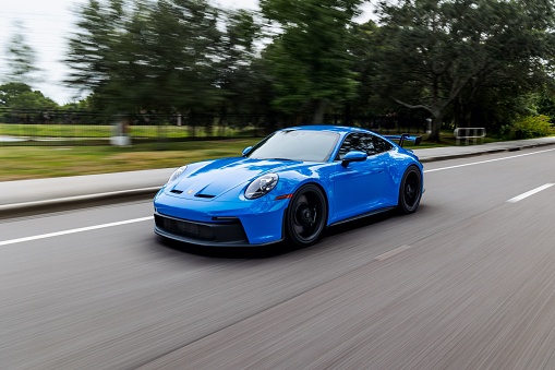 Saint Petersburg, United States – June 05, 2022: A modern blue Porsche 911 GT3 sportscar in motion