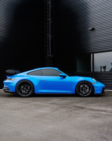 Saint Petersburg, United States – June 05, 2022: A vertical side view of a modern blue Porsche 911 GT3 sportscar parked
