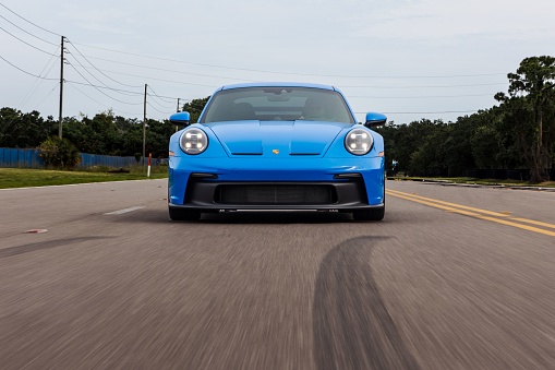 Saint Petersburg, United States – June 05, 2022: A front view of a modern blue Porsche 911 GT3 sportscar in motion