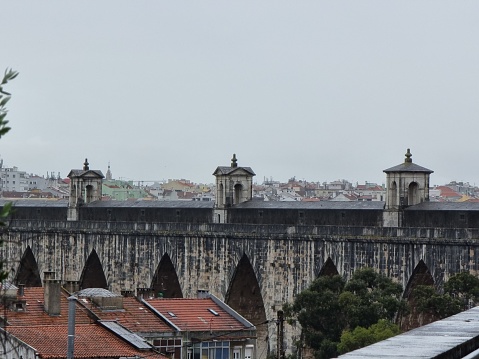 Lisbon, Portugal – April 21, 2022: A view of the old Lisbon Aqueduct overlooking residential urban buildings