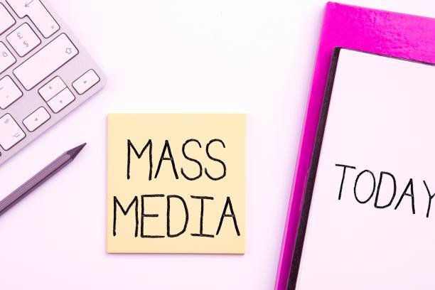 istock Colorful illustration of a keyboard, glasses, a notebook and a note with mass media text on it 1445355722
