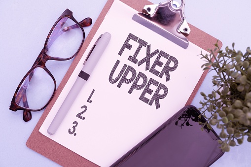 A colorful illustration of glasses, a smartphone, a pen and a paper holder with fixer upper text on it