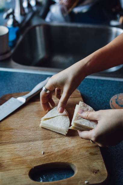 istock woman cutting tortillas into triangles to make tortilla chips 1445356639