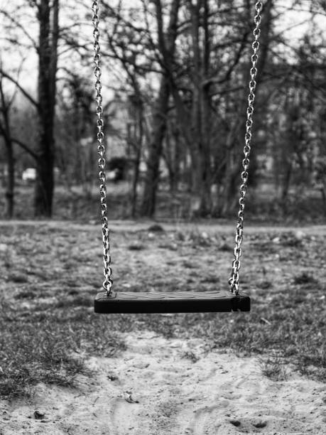 istock Grayscale of a swing seat in a park 1445358267