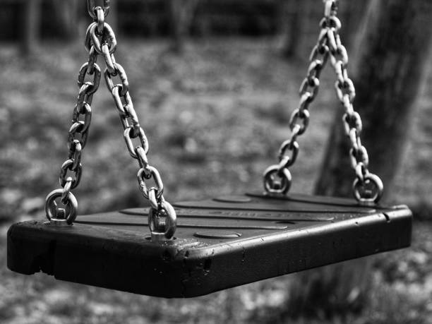 istock Grayscale of a swing seat in a park 1445358292