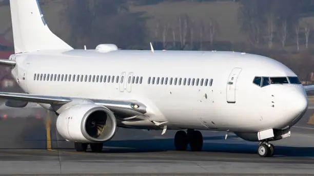 A closeup of the white Boeing 737-800 taxing after landing at Krakow Balice Airport
