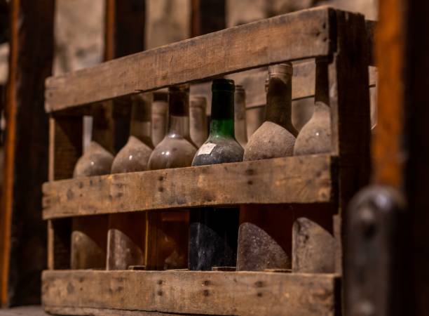 istock Closeup of underground wine bottles stacked on rows 1445359109