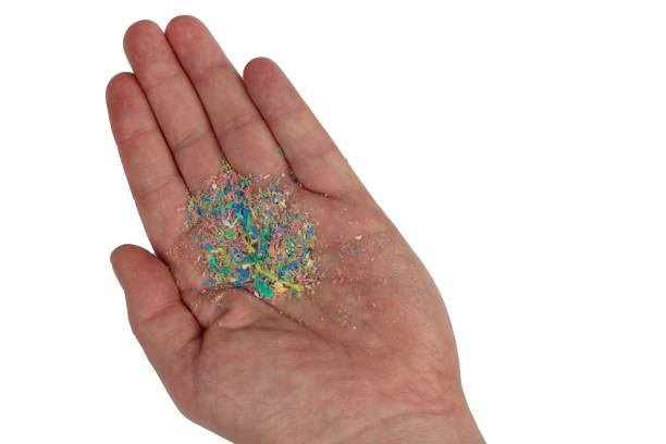 istock Micro plastic on hand. Top shot, isolated from the background. 1445359122